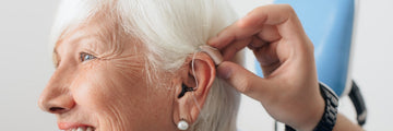 Older lady having a behind the ear hearing aid fitter