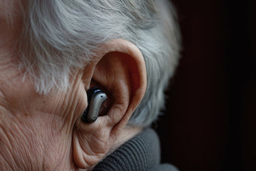 senior man wearing a bluetooth hearing aids