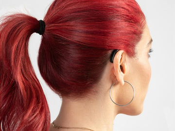 beautiful woman with red hair wearing hearing aids