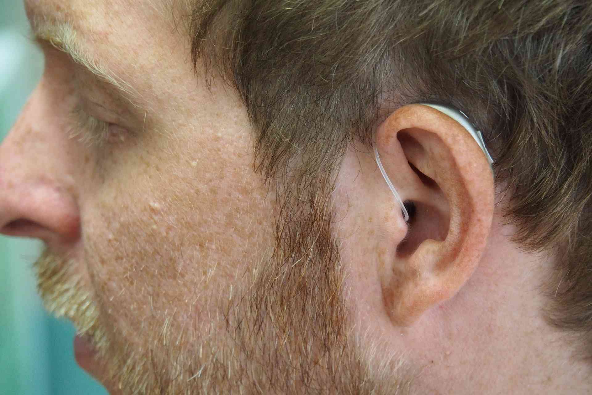 a man with behind the ear hearing aid