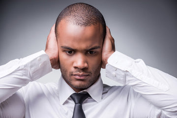 young man with both his hands covering his ears